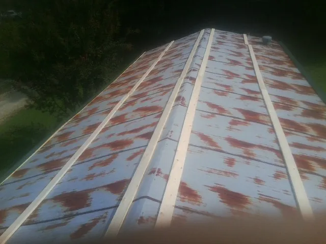 Rusted metal roof panels with new wood purlins before replacement — Storm Damage Roof Repair in Shepherdstown by Roofing Brothers