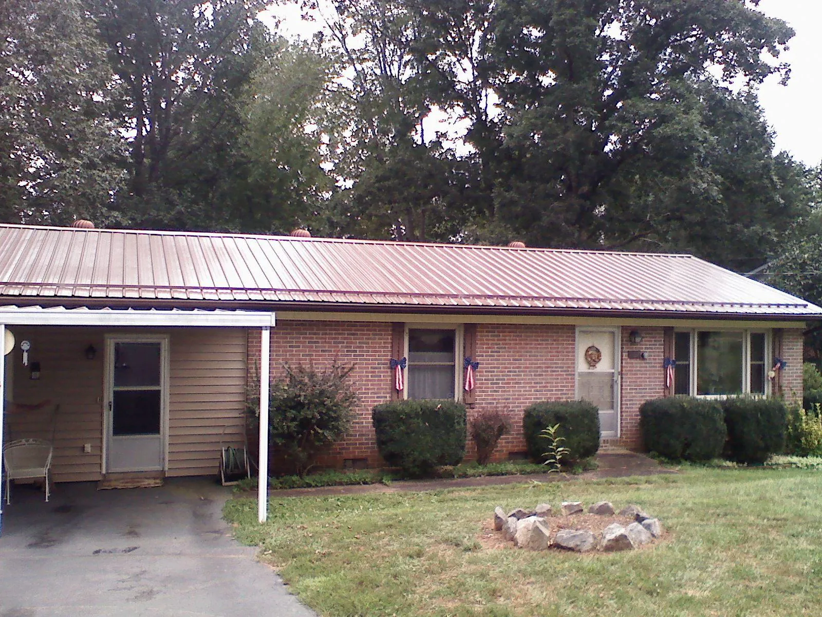 Bronze metal roof and carport on a brick ranch home — Roof Repair work by our crew in Shepherdstown