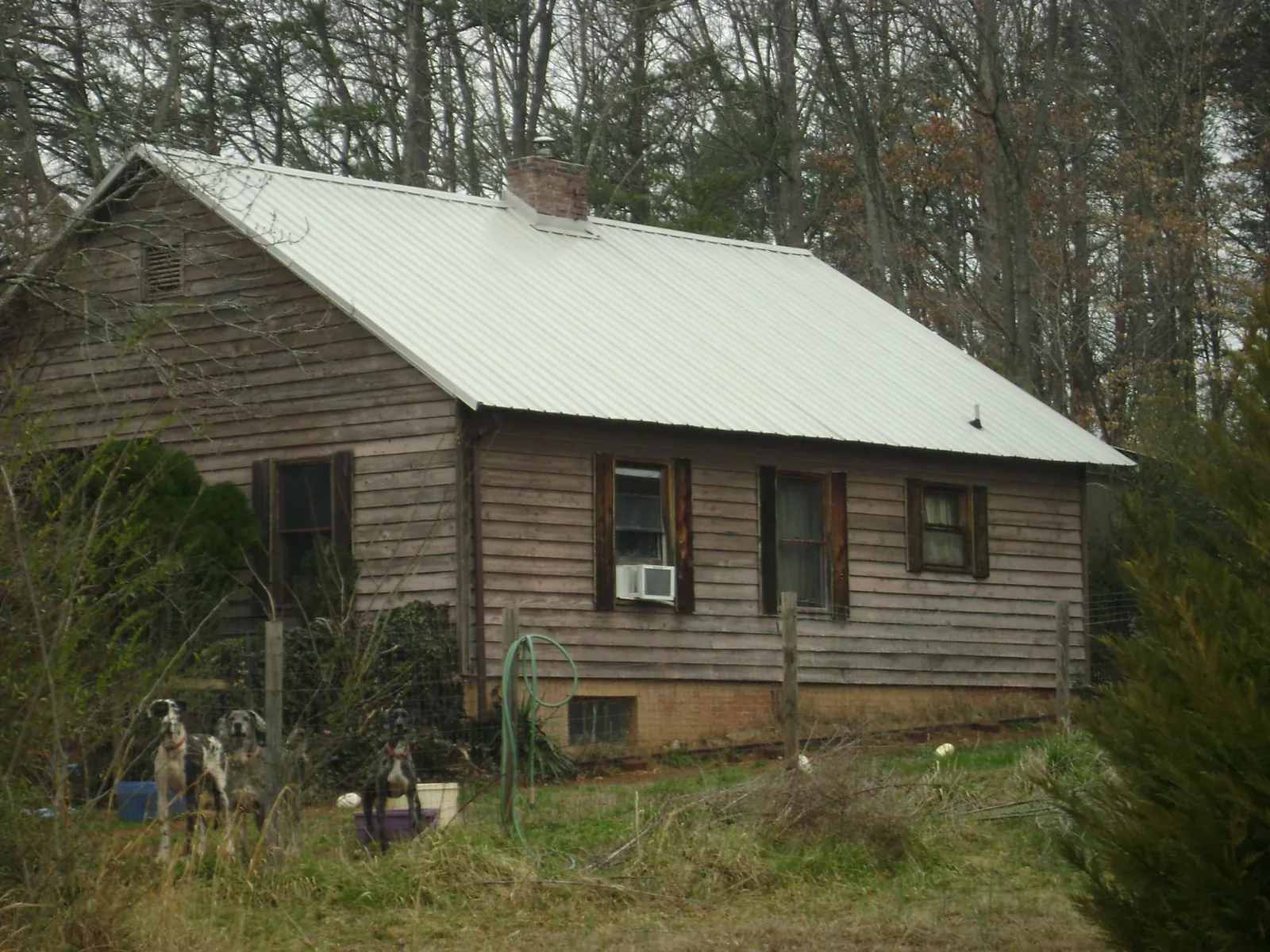 White metal roof on an old wood sided farmhouse, from a Metal Roof Installation job in Shepherdstown
